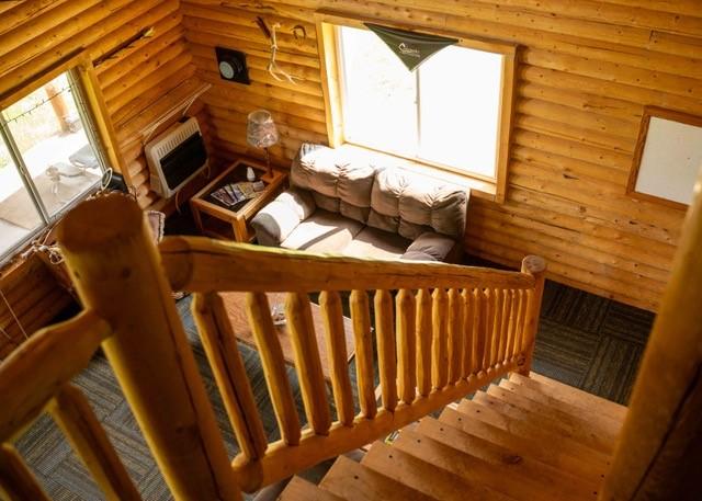 80 Sapling Ln, Craig, CO 81625 - staircase with log walls, hardwood / wood-style flooring, and heating unit