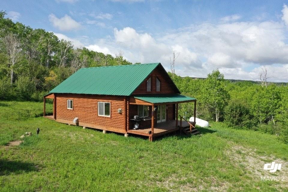 80 Sapling Ln, Craig, CO 81625 - back of property featuring a deck, a yard, faux log siding, and metal roof