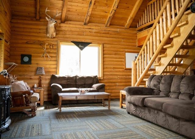 80 Sapling Ln, Craig, CO 81625 - living room featuring wood ceiling, stairway, and log walls