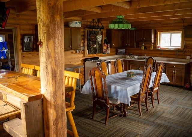 80 Sapling Ln, Craig, CO 81625 - carpeted dining area with log walls and a sink