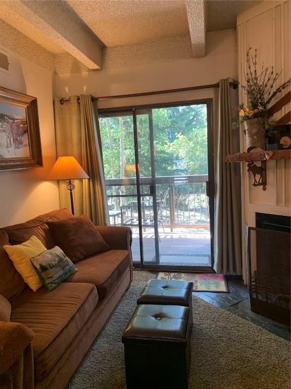 222 Creekside Dr Unit 112, Frisco, CO 80443 - living area featuring beam ceiling and a large fireplace