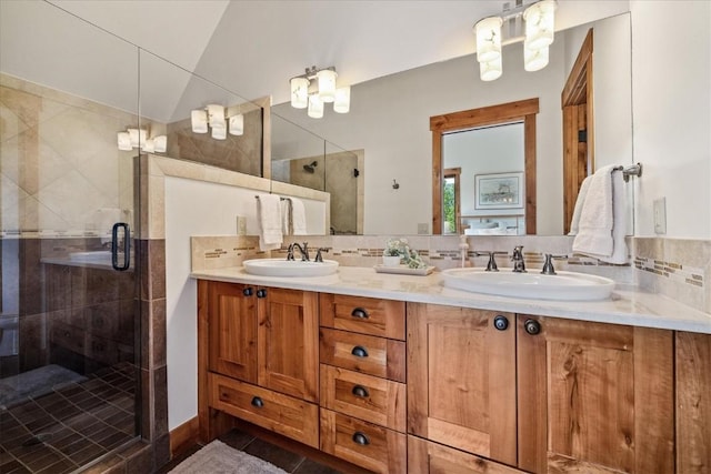 240 Two Cabins Dr, Silverthorne, CO 80498 - full bath with double vanity, a shower stall, tasteful backsplash, and a chandelier