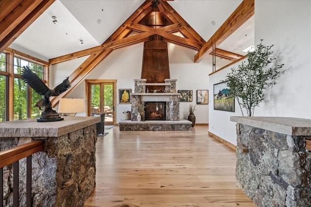 240 Two Cabins Dr, Silverthorne, CO 80498 - living area featuring high vaulted ceiling, wood finished floors, a large fireplace, and beam ceiling