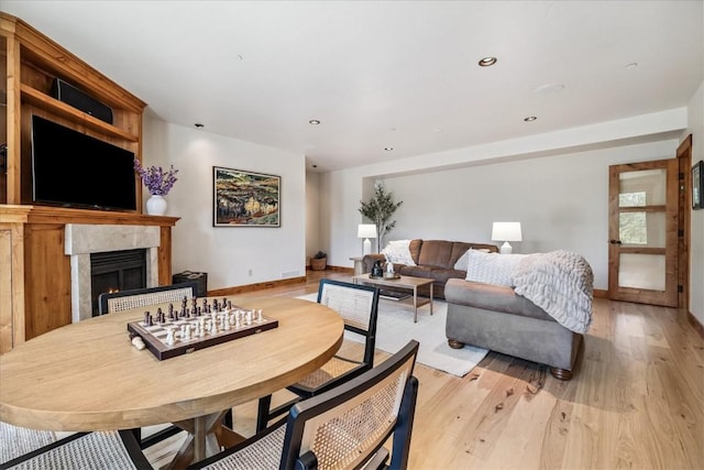 240 Two Cabins Dr, Silverthorne, CO 80498 - dining room with a premium fireplace, light wood finished floors, and recessed lighting