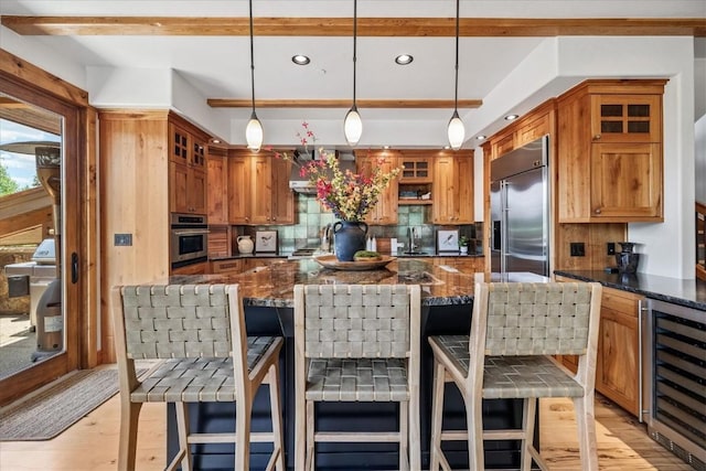 240 Two Cabins Dr, Silverthorne, CO 80498 - kitchen with stainless steel appliances, beverage cooler, tasteful backsplash, glass insert cabinets, and light wood-style floors