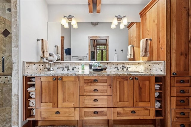 240 Two Cabins Dr, Silverthorne, CO 80498 - bathroom featuring double vanity, tasteful backsplash, and tiled shower