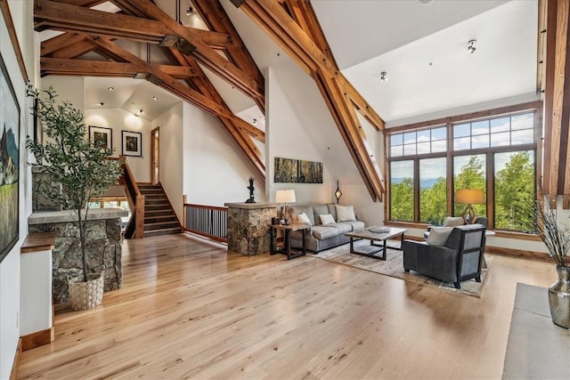 240 Two Cabins Dr, Silverthorne, CO 80498 - living room featuring wood finished floors, stairway, and high vaulted ceiling
