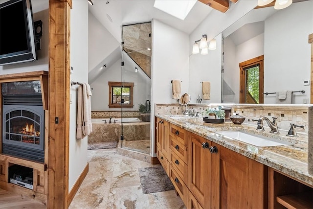 240 Two Cabins Dr, Silverthorne, CO 80498 - full bath with lofted ceiling, plenty of natural light, double vanity, a bath, and a skylight