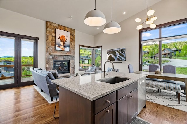 18 Lena Way, Silverthorne, CO 80498 - kitchen with a sink, wood finished floors, stainless steel dishwasher, dark brown cabinetry, and lofted ceiling