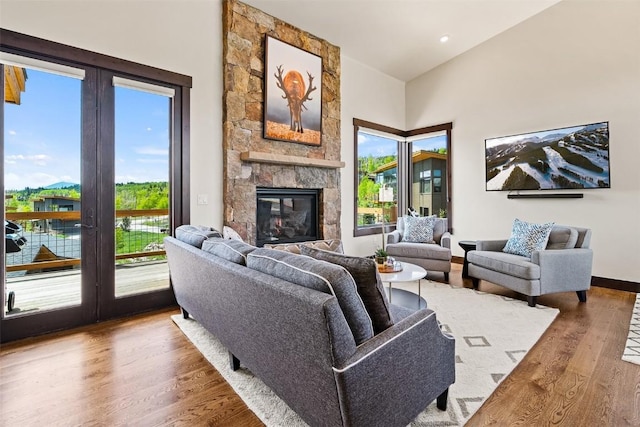 18 Lena Way, Silverthorne, CO 80498 - living room featuring wood finished floors, a fireplace, and vaulted ceiling