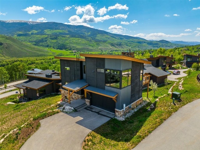 18 Lena Way, Silverthorne, CO 80498 - view of front of house featuring a mountain view, stone siding, and driveway