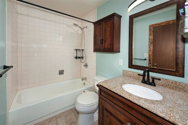 bathroom featuring washtub / shower combination, toilet, vanity, and tile patterned floors