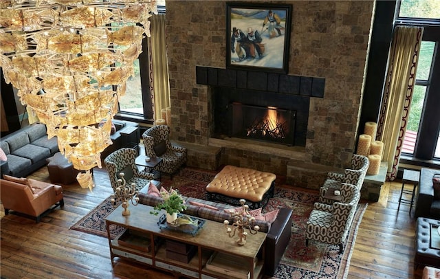 living area with wood-type flooring and a glass covered fireplace