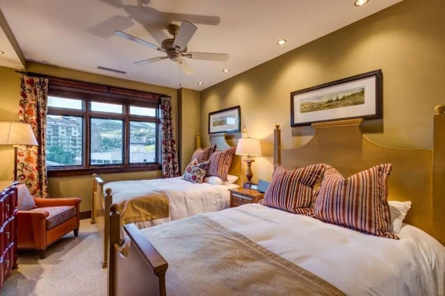 carpeted bedroom featuring ceiling fan, visible vents, and recessed lighting