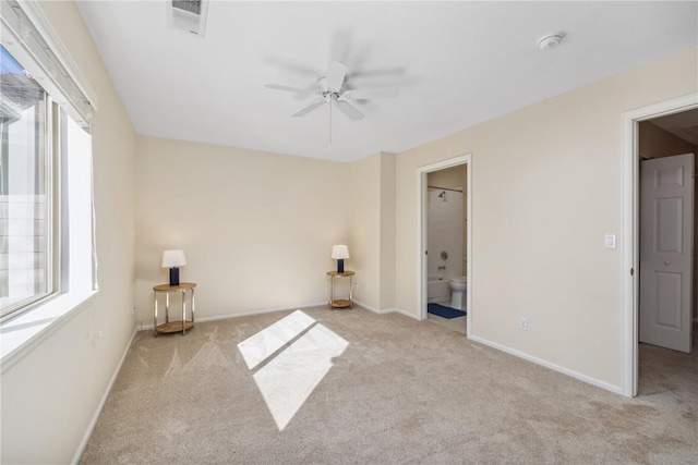 unfurnished bedroom featuring carpet floors, visible vents, baseboards, and multiple windows