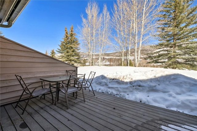 snow covered deck with outdoor dining space