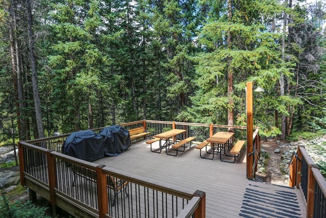805 Columbine Rd Unit 105, Breckenridge, CO 80424 - wooden terrace with outdoor dining area and a wooded view