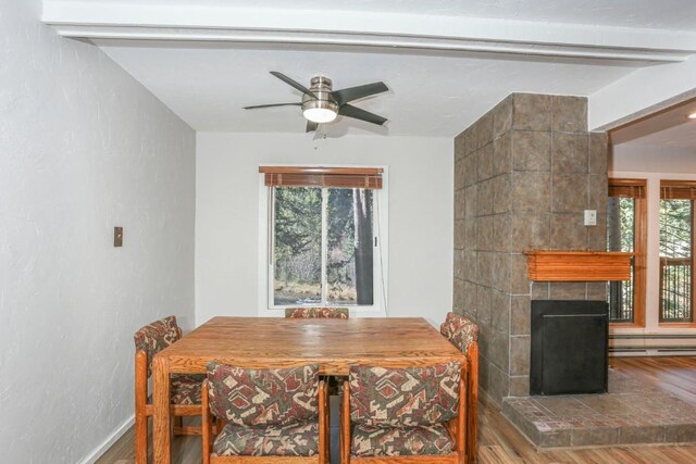 805 Columbine Rd Unit 105, Breckenridge, CO 80424 - dining space with wood finished floors, a large fireplace, and ceiling fan