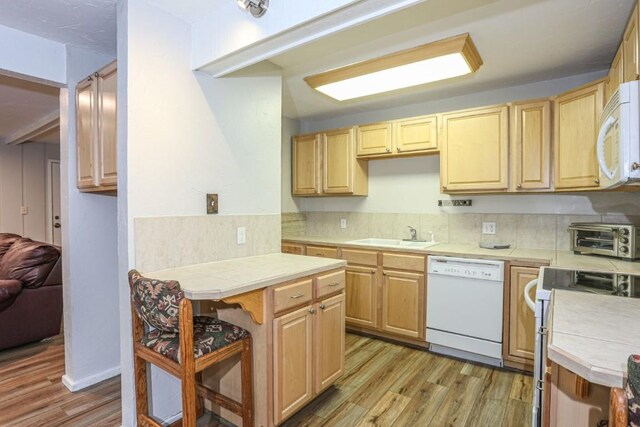 805 Columbine Rd Unit 105, Breckenridge, CO 80424 - kitchen featuring a sink, tile countertops, white appliances, a toaster, and light wood-style flooring