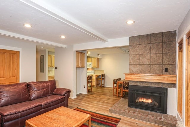 805 Columbine Rd Unit 105, Breckenridge, CO 80424 - living area featuring a tile fireplace, light wood-style flooring, baseboards, beam ceiling, and recessed lighting