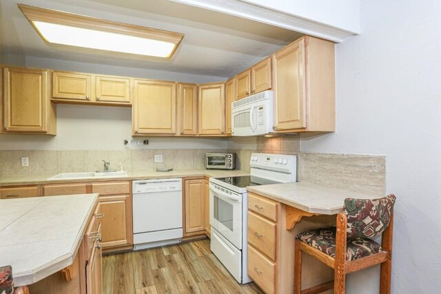 805 Columbine Rd Unit 105, Breckenridge, CO 80424 - kitchen featuring tile counters, light brown cabinetry, backsplash, a sink, and white appliances