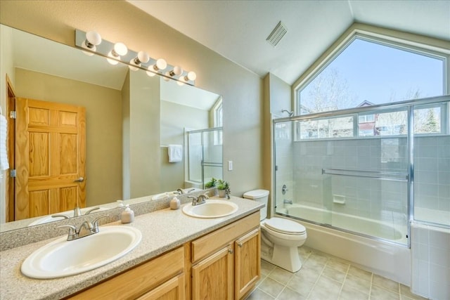 81 Cydney Ln Unit 81A, Silverthorne, CO 80498 - full bath with healthy amount of natural light, lofted ceiling, toilet, shower / bath combination with glass door, and double vanity