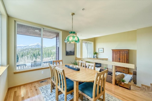 81 Cydney Ln Unit 81A, Silverthorne, CO 80498 - dining room with a mountain view, light wood-style flooring, and baseboards