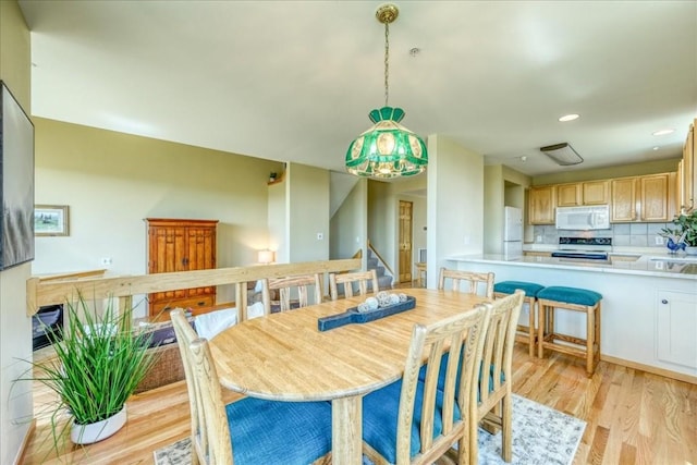 81 Cydney Ln Unit 81A, Silverthorne, CO 80498 - dining room featuring light wood finished floors, stairway, and recessed lighting