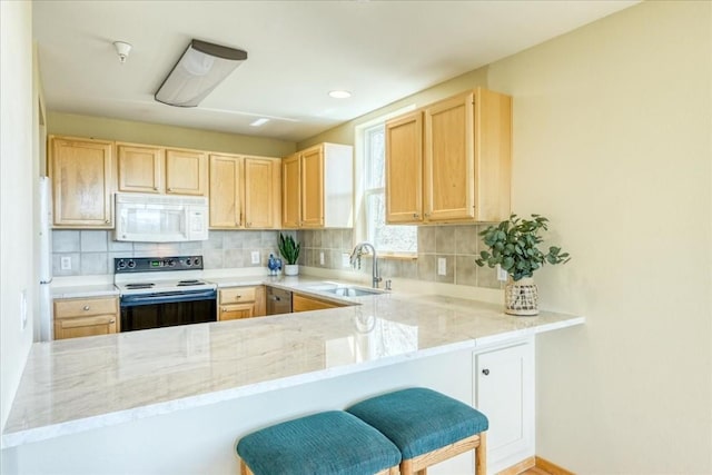 81 Cydney Ln Unit 81A, Silverthorne, CO 80498 - kitchen with white microwave, electric stove, a sink, light brown cabinets, and recessed lighting