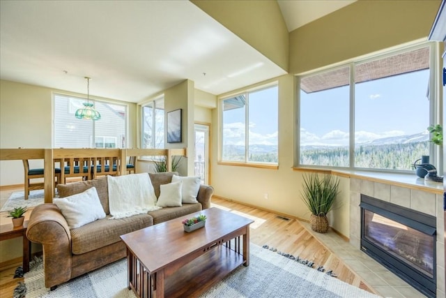 81 Cydney Ln Unit 81A, Silverthorne, CO 80498 - living room featuring light wood-type flooring and a tile fireplace