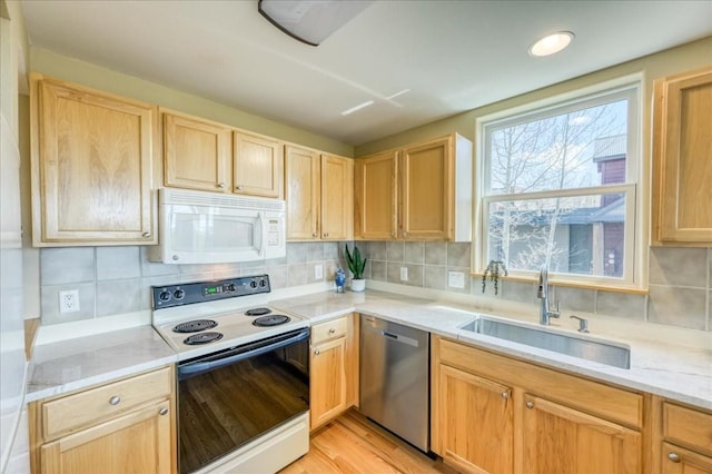81 Cydney Ln Unit 81A, Silverthorne, CO 80498 - kitchen with white microwave, range with electric cooktop, stainless steel dishwasher, a sink, and light brown cabinets
