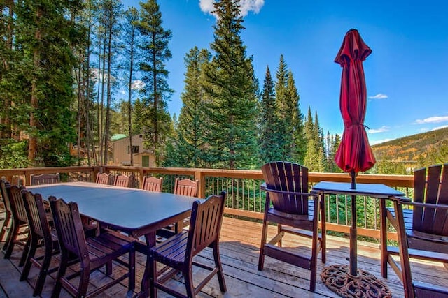 wooden terrace featuring outdoor dining area