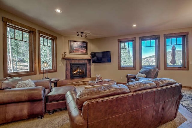 living room with a lit fireplace and recessed lighting