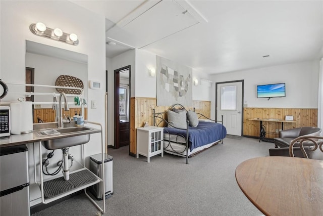 114 N French St, Breckenridge, CO 80424 - bedroom featuring wood walls, a wainscoted wall, carpet floors, and fridge