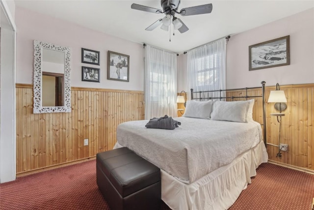 114 N French St, Breckenridge, CO 80424 - carpeted bedroom with wooden walls, wainscoting, and a ceiling fan