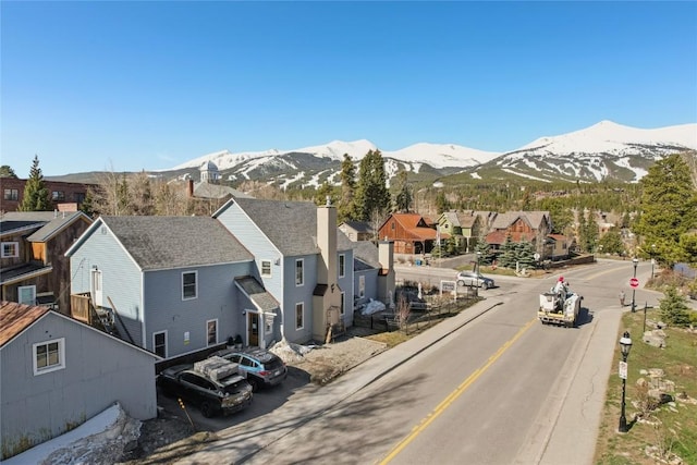 114 N French St, Breckenridge, CO 80424 - view of asphalt street featuring a residential view, a mountain view, traffic signs, and curbs