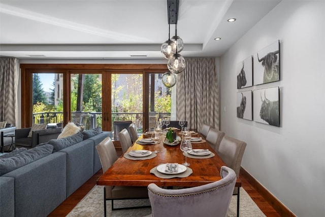 dining space with baseboards, wood finished floors, and recessed lighting