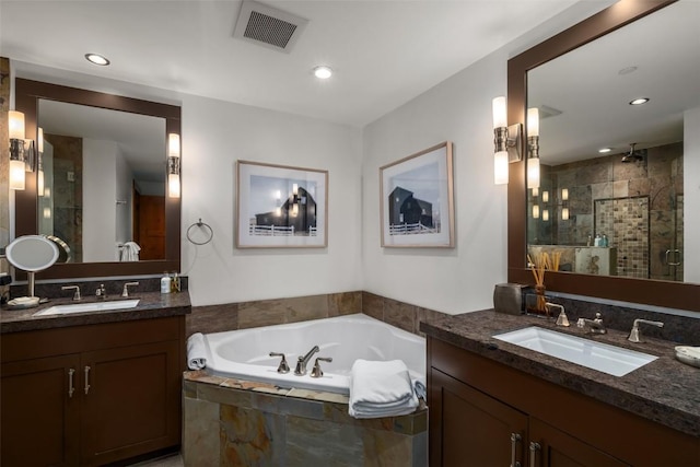 full bathroom featuring a bath, visible vents, a sink, and a shower stall