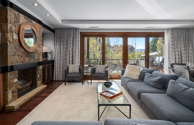 living room with a fireplace, wood finished floors, a healthy amount of sunlight, and recessed lighting