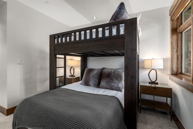 bedroom with baseboards, carpet flooring, and multiple windows