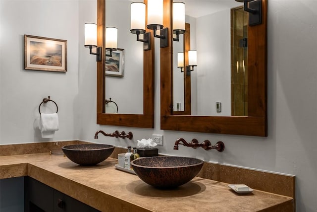 bathroom with a sink and double vanity
