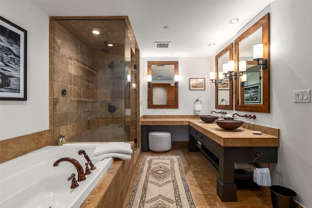 bathroom with a shower stall, a garden tub, vanity, visible vents, and recessed lighting