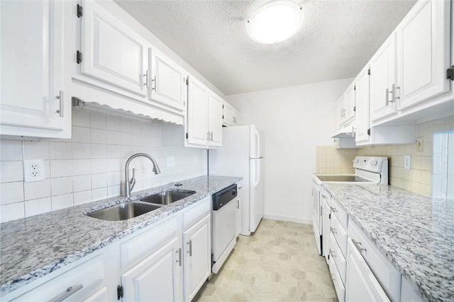 245 Straight Creek Dr Unit A, B, C, D, Dillon, CO 80435 - kitchen with white appliances, a sink, under cabinet range hood, white cabinetry, and baseboards