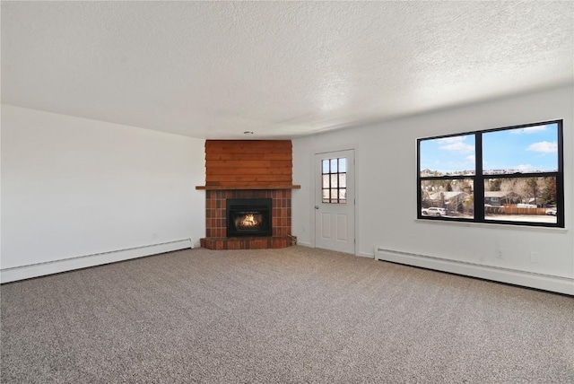 245 Straight Creek Dr Unit A, B, C, D, Dillon, CO 80435 - unfurnished living room featuring a textured ceiling, a tile fireplace, a baseboard heating unit, and carpet floors