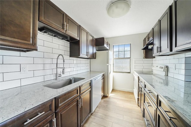 245 Straight Creek Dr Unit A, B, C, D, Dillon, CO 80435 - kitchen featuring a sink, white appliances, under cabinet range hood, baseboards, and tasteful backsplash