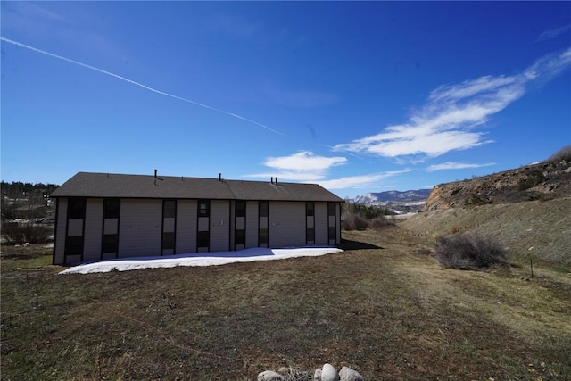 rear view of property featuring a lawn and a patio area