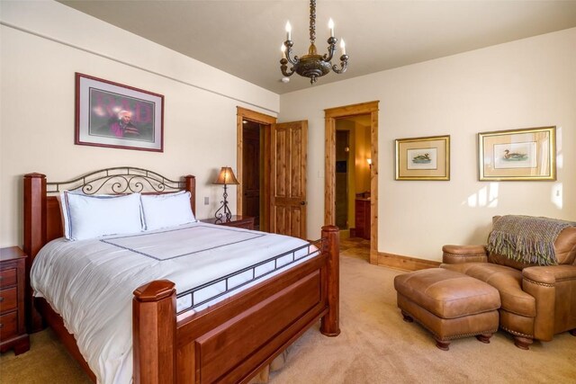 33800 Catamount Dr, Steamboat Springs, CO 80487 - bedroom with light carpet, a chandelier, and baseboards