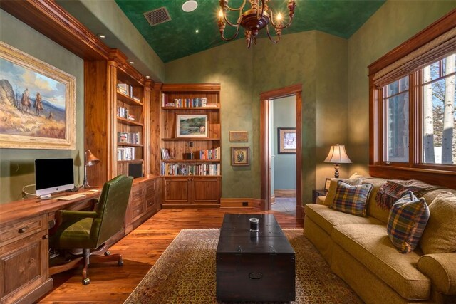 33800 Catamount Dr, Steamboat Springs, CO 80487 - office featuring wood finished floors, a chandelier, lofted ceiling, built in shelves, and baseboards