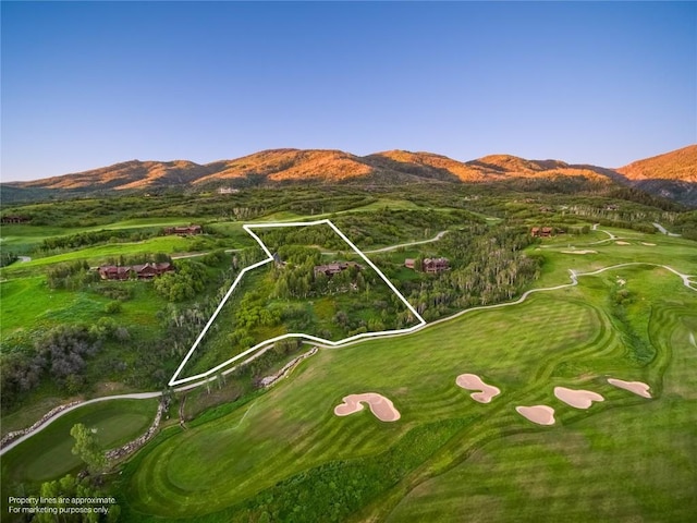 33800 Catamount Dr, Steamboat Springs, CO 80487 - aerial view of property's location featuring a mountainous background, property boundaries highlighted, and a local golf course