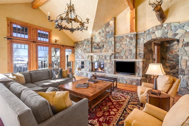 33800 Catamount Dr, Steamboat Springs, CO 80487 - living room featuring a stone fireplace, high vaulted ceiling, a chandelier, beam ceiling, and wood finished floors